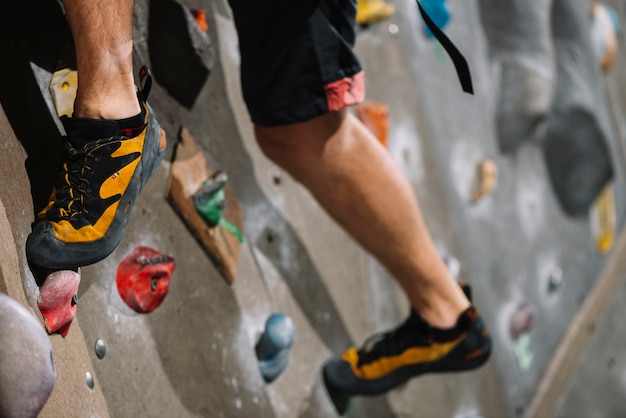 Crop legs on climbing wall