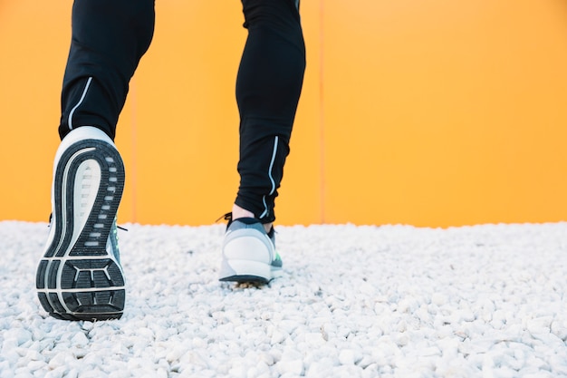 Crop legs in sneakers running 