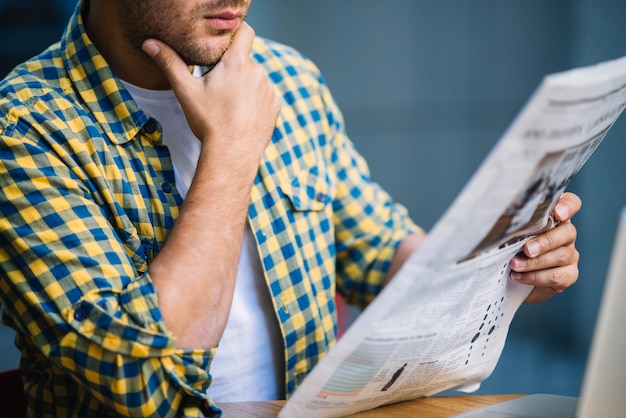 Crop man concentrated on news