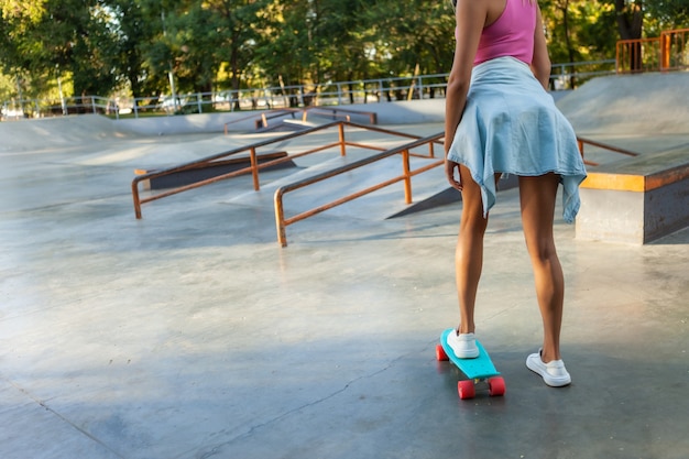 Crop photo of female skater with cruiser board at skatepark