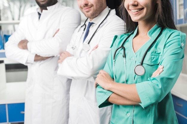 Crop smiling medics in hospital