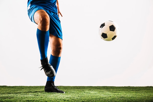 Crop soccer player and ball