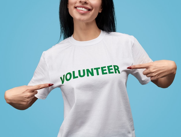 Photo crop volunteer pointing at t-shirt