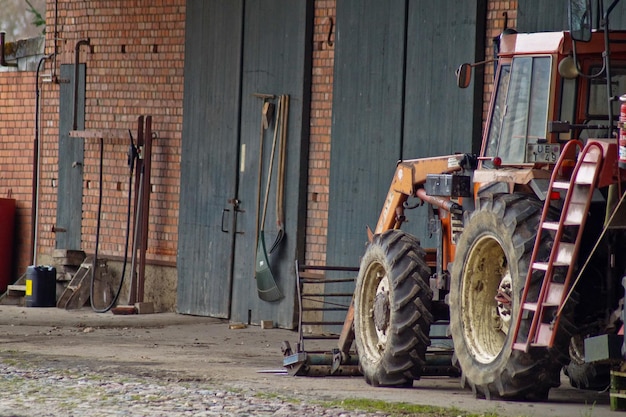 Photo cropped agricultural vehicle against the brick wall