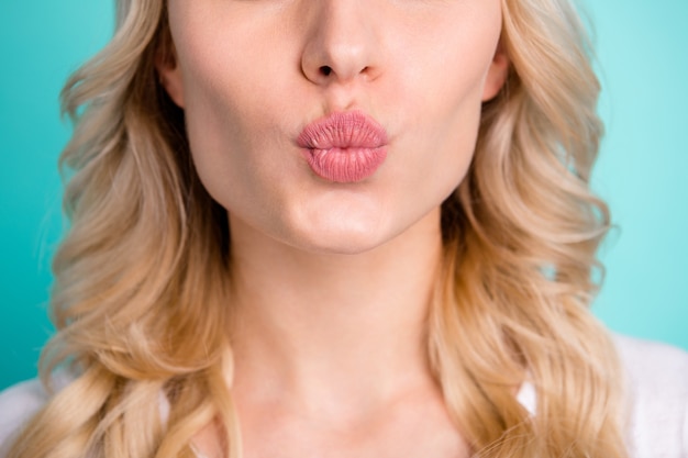 cropped of blonde girl pouted lips send air kiss