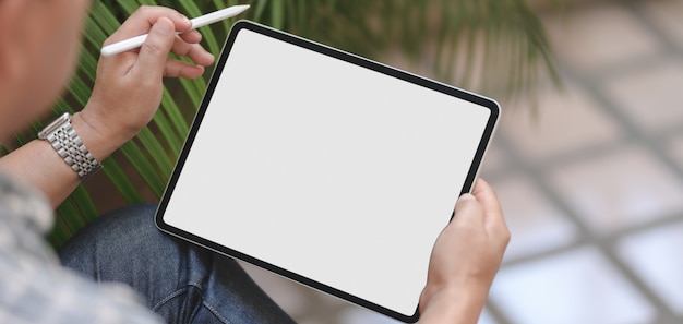 Cropped of businessman using blank screen digital tablet while working on his project