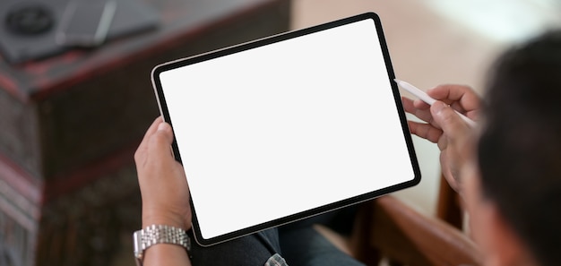 Cropped of businessman using blank screen digital tablet while working on his project