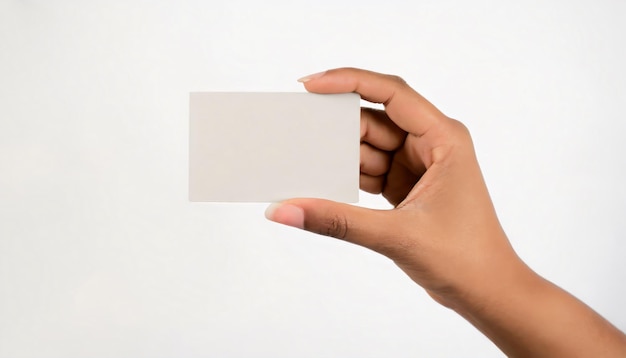 Cropped close up of human hand showing empty blank card on gray background with copy space