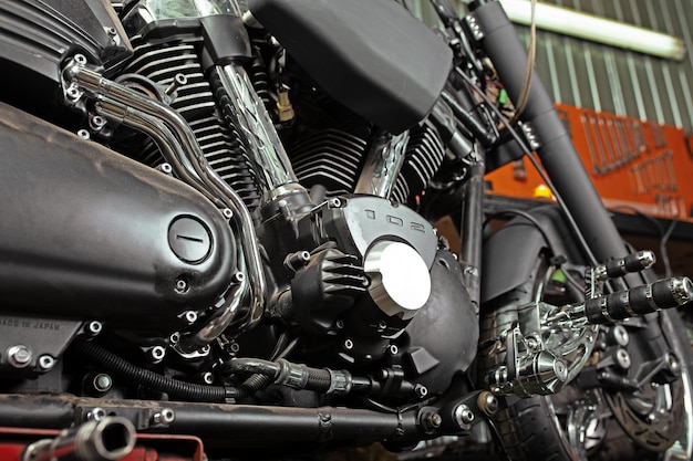 Cropped close up shot of beautiful and custom made motorcycle in the workshop