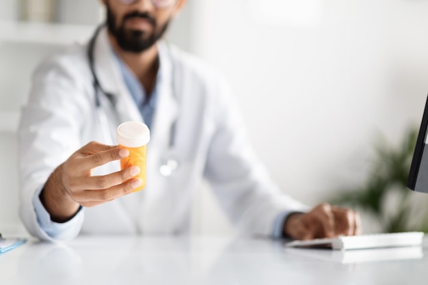 Cropped of doctor holding box with nedication clinic interior