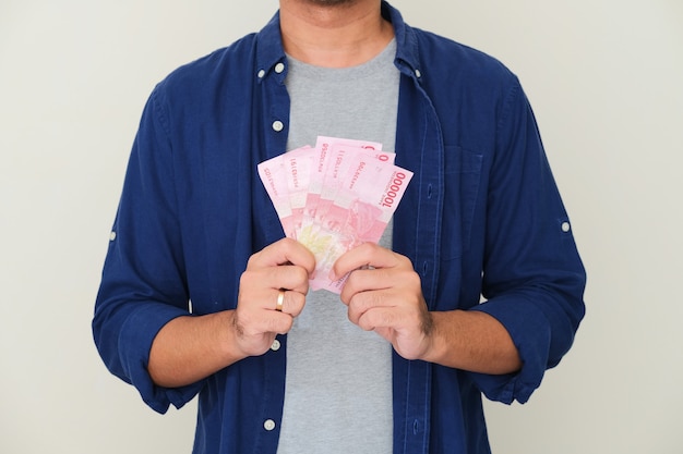 Cropped guy showing paper money