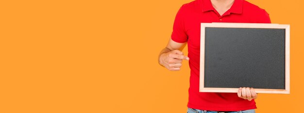 Cropped guy with bristle point finger on chalkboard with copy space announcement