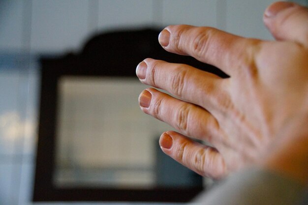 Cropped hand against window