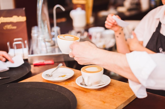 カフェでコーヒーを飲むバリスタの手を切った
