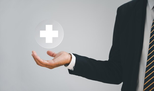 Cropped hand of businessman gesturing against white background