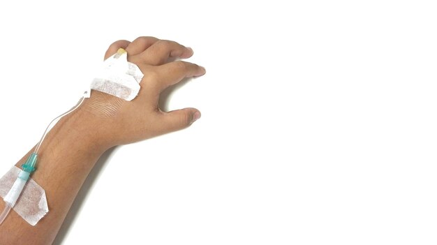 Photo cropped hand of child with iv drip against white background