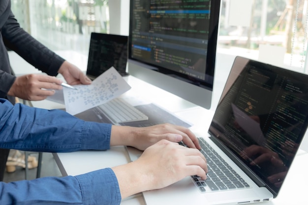 Premium Photo | Cropped hand of computer programmers brainstorming in ...