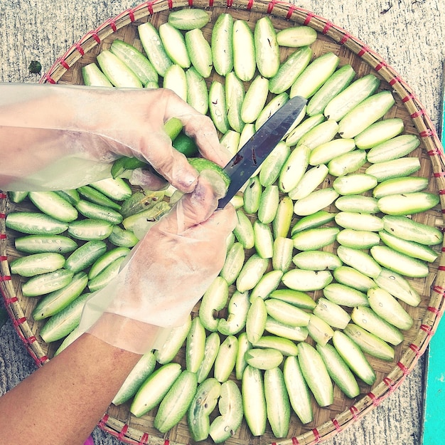 Cropped hand cutting fruit