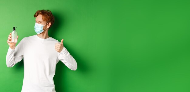 Photo cropped hand of doctor holding thermometer against blue background