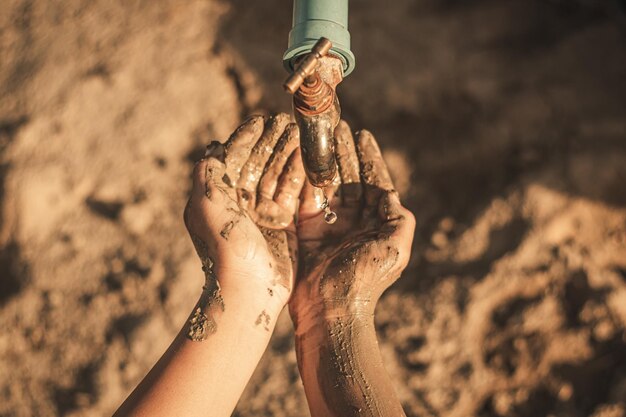 Photo cropped hand under faucet