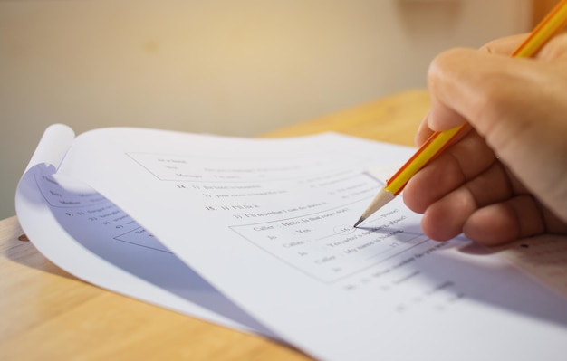 Cropped hand filling form on table