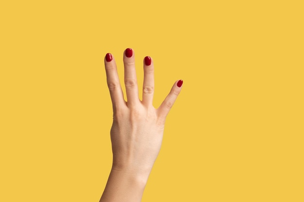 Photo cropped hand gesturing against yellow background