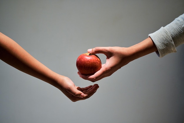 Cropped hand holding apple