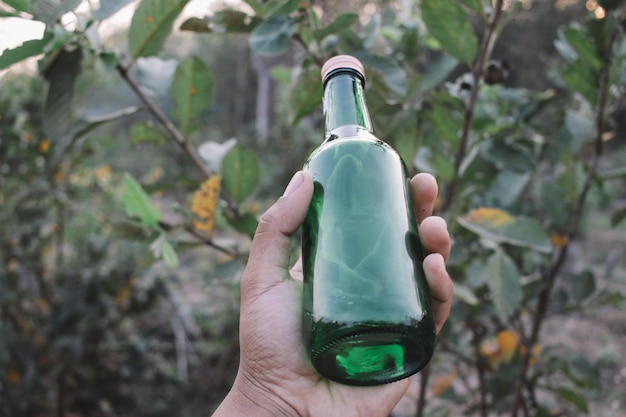 Photo cropped hand holding bottle