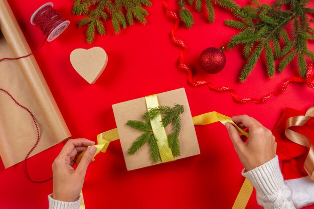 Cropped hand holding christmas present on table