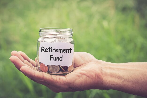 Cropped hand holding coin jar with message