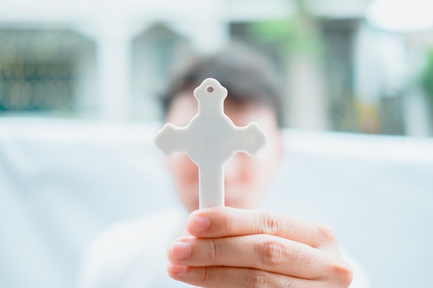 cropped hand holding cross