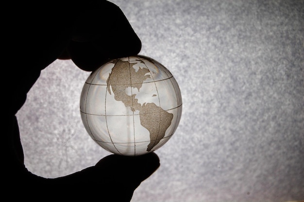 Cropped hand holding globe