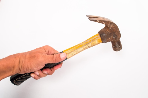 Photo cropped hand holding hammer against white background