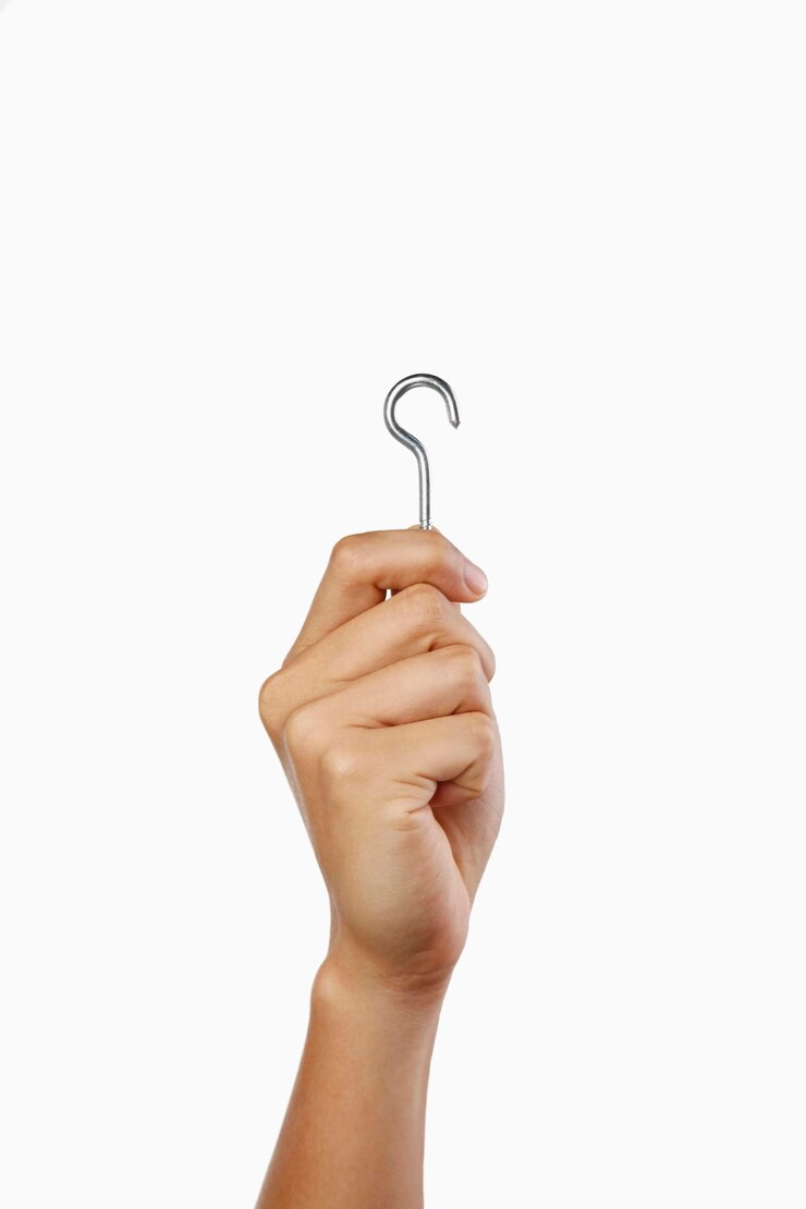 Photo cropped hand holding hook over white background