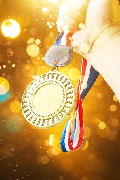 Photo cropped hand holding medal