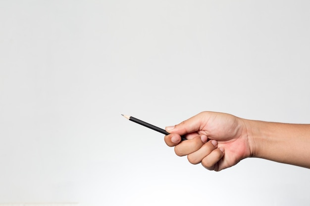 Photo cropped hand holding pencil against white background