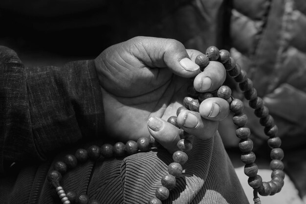 Photo cropped hand holding prayer beads