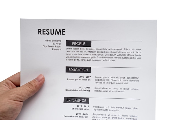 Cropped hand holding resume over white background