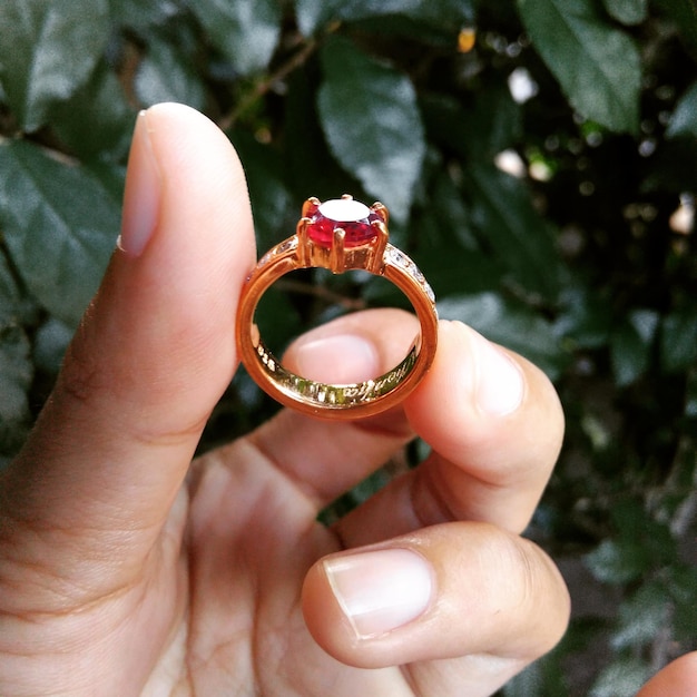 Photo cropped hand holding ring