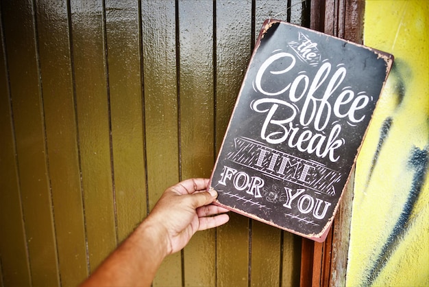 Photo cropped hand holding signboard