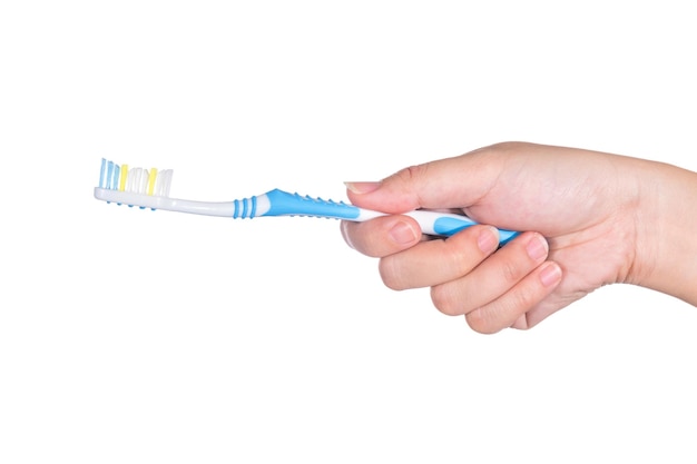 cropped hand holding toothbrush against white background