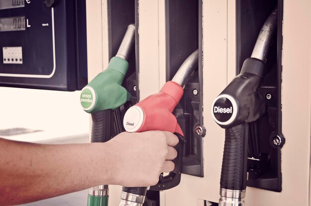 Photo cropped hand of man holding fuel pump