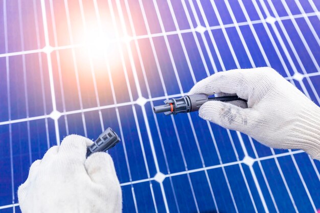 Cropped hand of man installing solar panel on rooftop