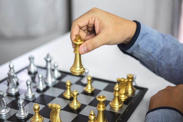 Cropped hand of man playing chess