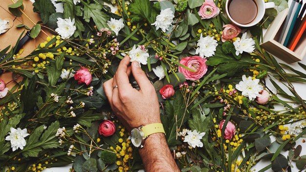 Cropped hand of man touching flowers