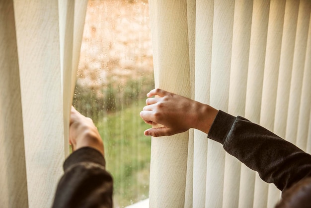 Photo cropped hand of man touching window