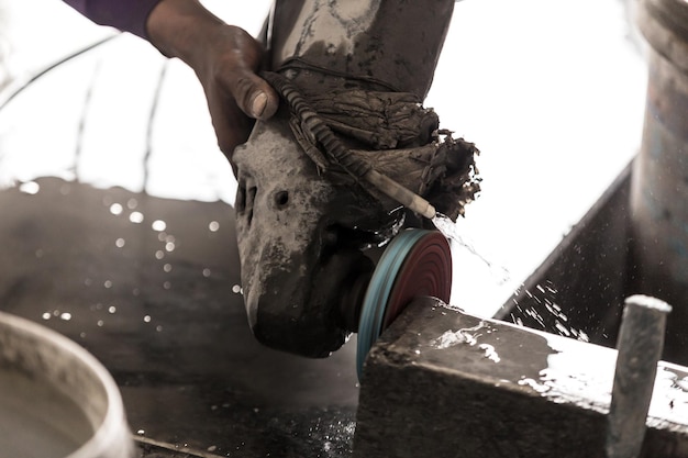 Photo cropped hand of man working with machine at construction site