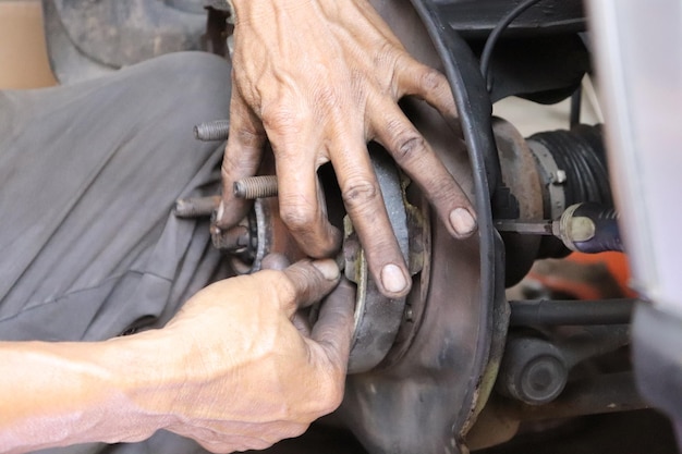 Cropped hand of mechanic working garage