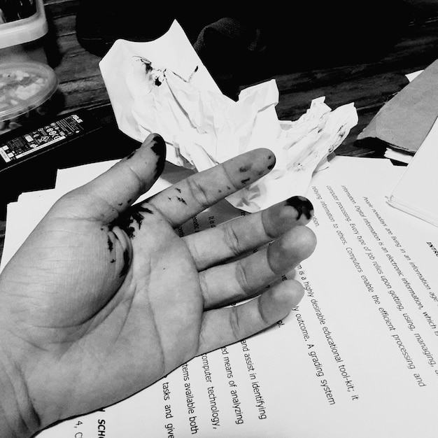cropped hand on paper with text