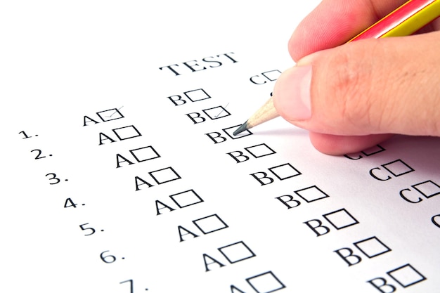 Photo cropped hand of person filling form with pencil